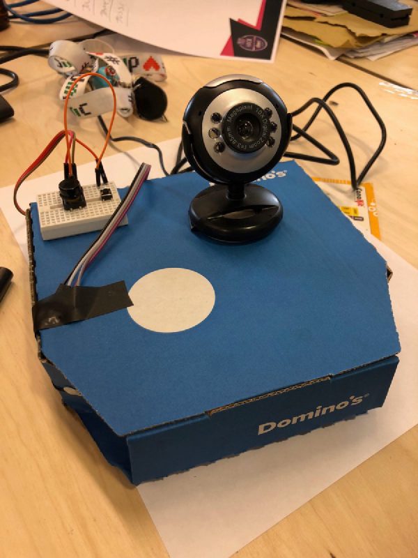 The Selfie Button taking shape on a Domino's box. A webcam, a breadboard, some wishful thinking.